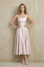 Front view of the LVLVS Abby blush midi dress, showing the square neckline, wide straps, ruched waist and flared skirt.