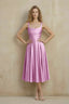 Front view of the LVLVS Abby candy midi dress, showing the square neckline, wide straps, ruched waist and flared skirt.
