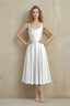 Front view of the LVLVS Abby white midi dress, showing the square neckline, wide straps, ruched waist and flared skirt.