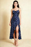 Front view of the LVLVS Ada navy polka dot midi dress, showing the draped neckline, thin straps and high-low ruffled skirt.