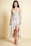 Front view of the LVLVS Ada white polka dot midi dress, showing the draped neckline, thin straps and high-low ruffled skirt.