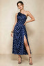 Front view of the LVLVS Alexa navy polka dot midi dress, showing the one-shoulder neckline, gathered waist detail and thigh-high skirt slit.