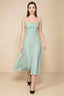 Front view of the LVLVS Alina agave midi dress, showing the draped neckline, thin shoulder straps and flowing flared skirt.