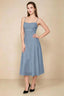 Front view of the LVLVS Alina dusty blue midi dress, showing the draped neckline, thin shoulder straps and flowing flared skirt.