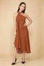 Front view of the LVLVS Alma burnt orange midi dress, showing the asymmetric neckline, draped neck scarf and flowing uneven hem.