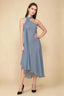 Front view of the LVLVS Alma dusty blue midi dress, showing the asymmetric neckline, draped neck scarf and flowing uneven hem.