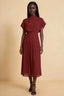 Front view of the LVLVS Alva rust midi dress, showing the high draped neckline, short sleeves and wide fitted waist panel.
