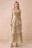 Front view of Ava champagne chiffon maxi dress with thin straps, a fitted bodice and cascading ruffle tiers