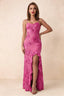 Front studio view of Brianna fuchsia floral maxi dress with thin straps and a high ruffle-edged opening