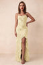 Front studio view of Brianna lemon floral maxi dress with thin straps and a high ruffle-edged opening