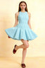 Light blue Cheryl crepe dress with round neck and pleated skater skirt, model posing in studio for homecoming or semi-formal event.