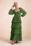 Front studio view of Sienna basil tiered pleated maxi dress with a long flowing skirt
