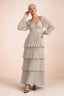 Front studio view of Sienna cream tiered pleated maxi dress with a long flowing skirt
