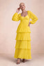 Front studio view of Sienna yellow tiered pleated maxi dress with a long flowing skirt