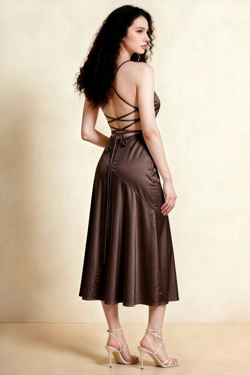 Back view of the LVLVS Ada chocolate brown midi dress, showing crossed straps, an open lace-up back and a longer rear hem.