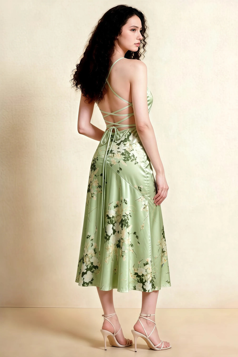 Translation missing: en.Back view of the LVLVS Ada green floral midi dress, showing crossed straps, an open lace-up back and a longer rear hem. content.product_image_secondary