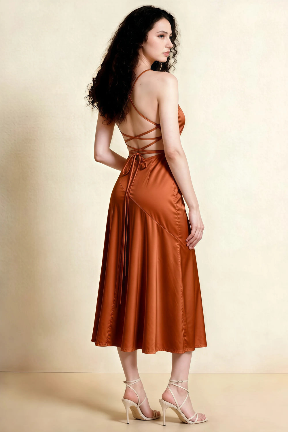 Translation missing: en.Back view of the LVLVS Ada rust midi dress, showing crossed straps, an open lace-up back and a longer rear hem. content.product_image_secondary
