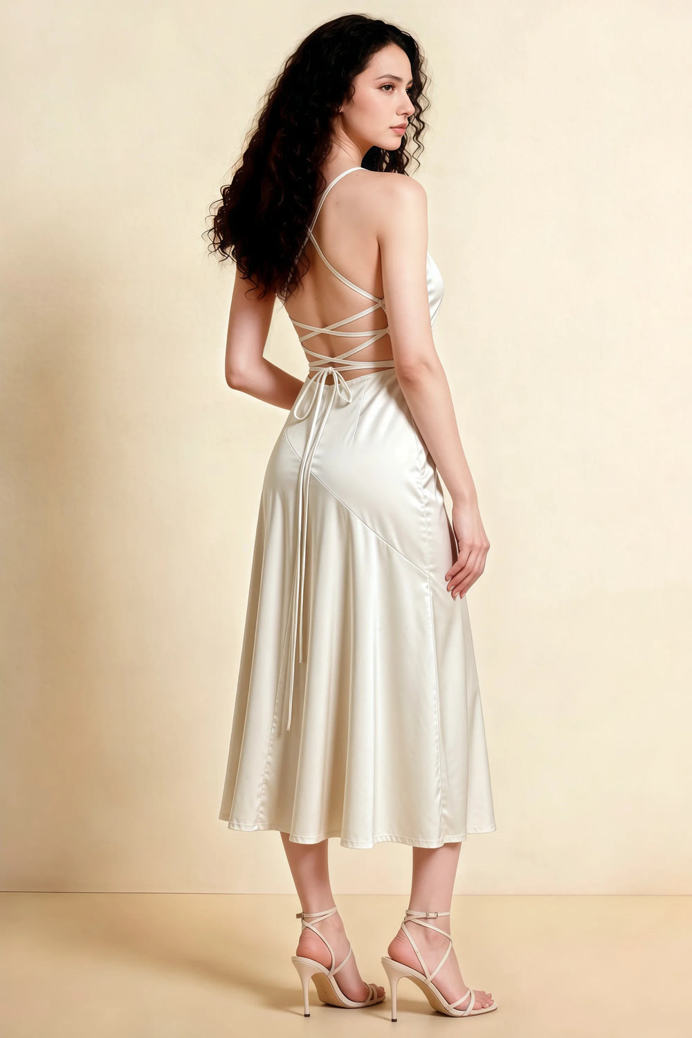Translation missing: en.Back view of the LVLVS Ada white midi dress, showing crossed straps, an open lace-up back and a longer rear hem. content.product_image_secondary