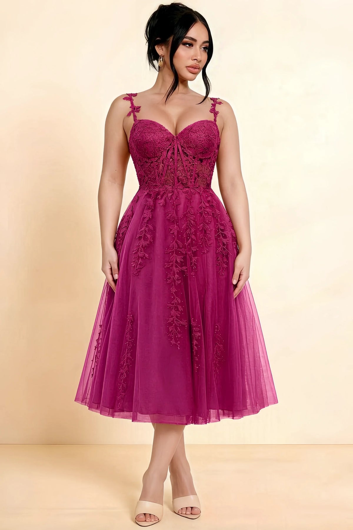 Full-length view of a model wearing the LVLVS Adeline fuchsia midi dress, showing the fitted lace bodice and flared calf-length skirt.