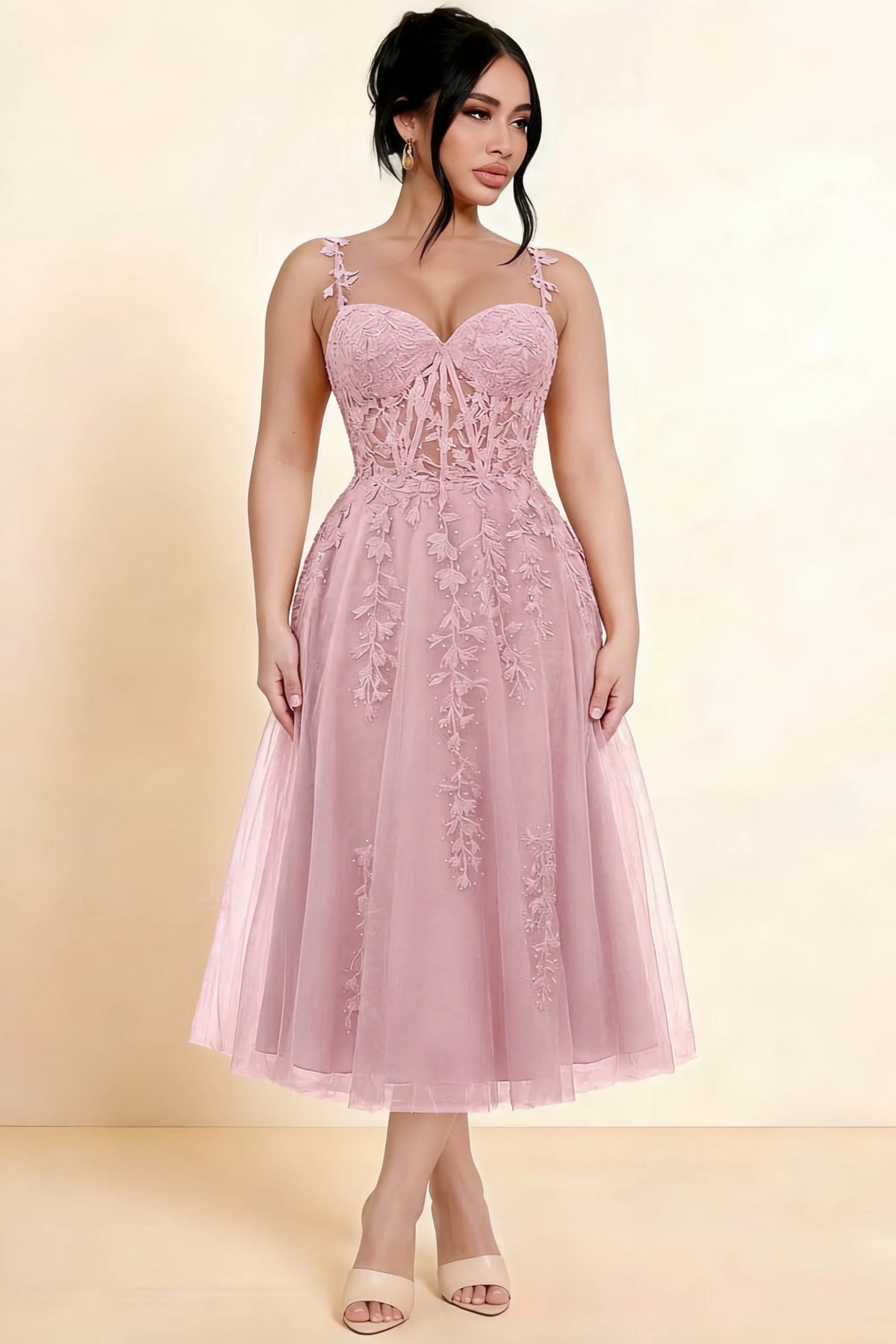 Full-length view of a model wearing the LVLVS Adeline light pink midi dress, showing the fitted lace bodice and flared calf-length skirt.