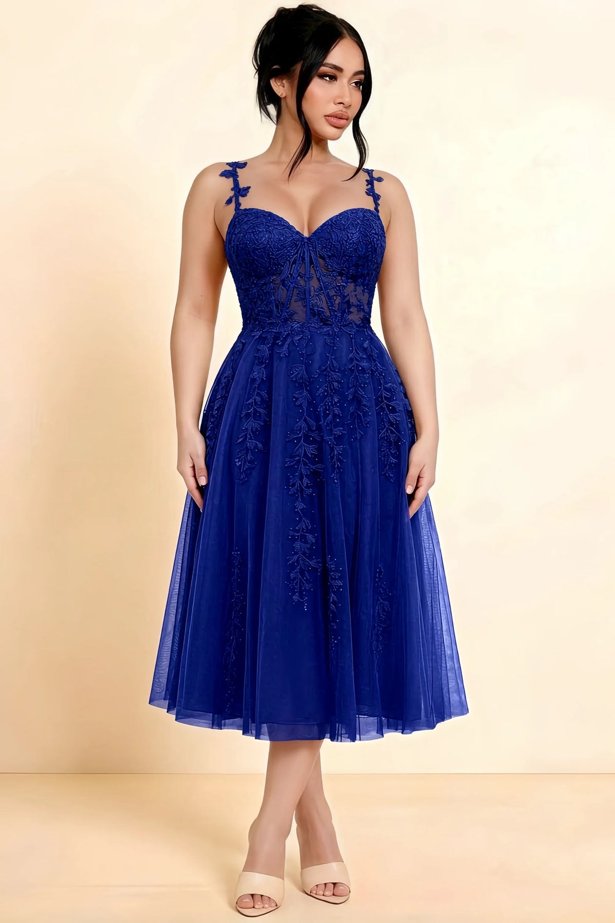 Full-length view of a model wearing the LVLVS Adeline royal blue midi dress, showing the fitted lace bodice and flared calf-length skirt.