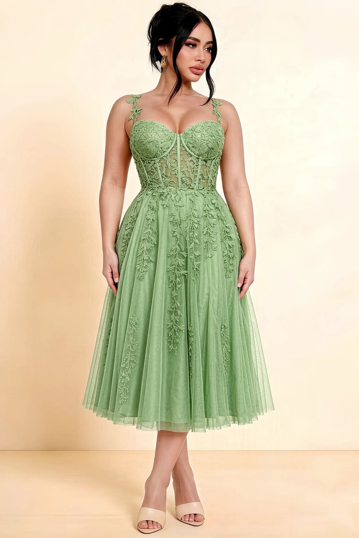 Full-length view of a model wearing the LVLVS Adeline sage green midi dress, showing the fitted lace bodice and flared calf-length skirt.