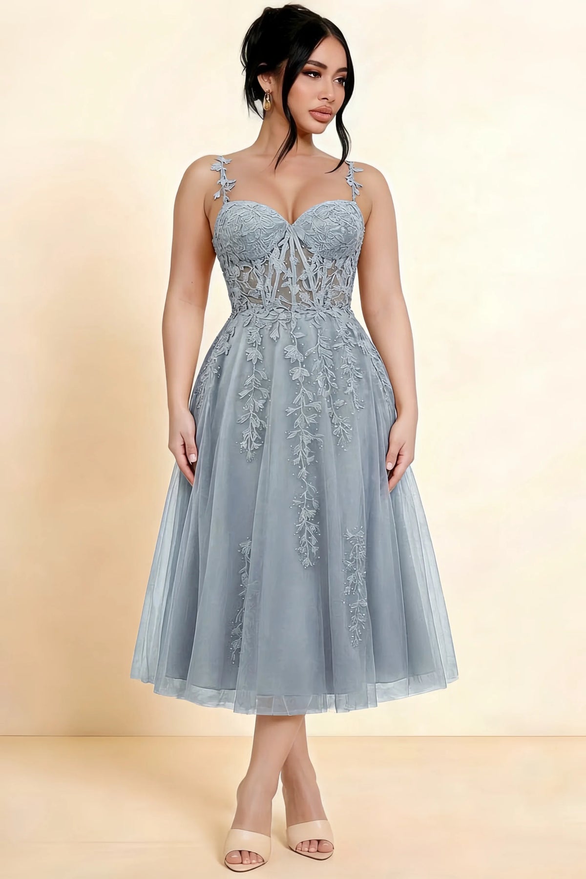 Full-length view of a model wearing the LVLVS Adeline silver midi dress, showing the fitted lace bodice and flared calf-length skirt.