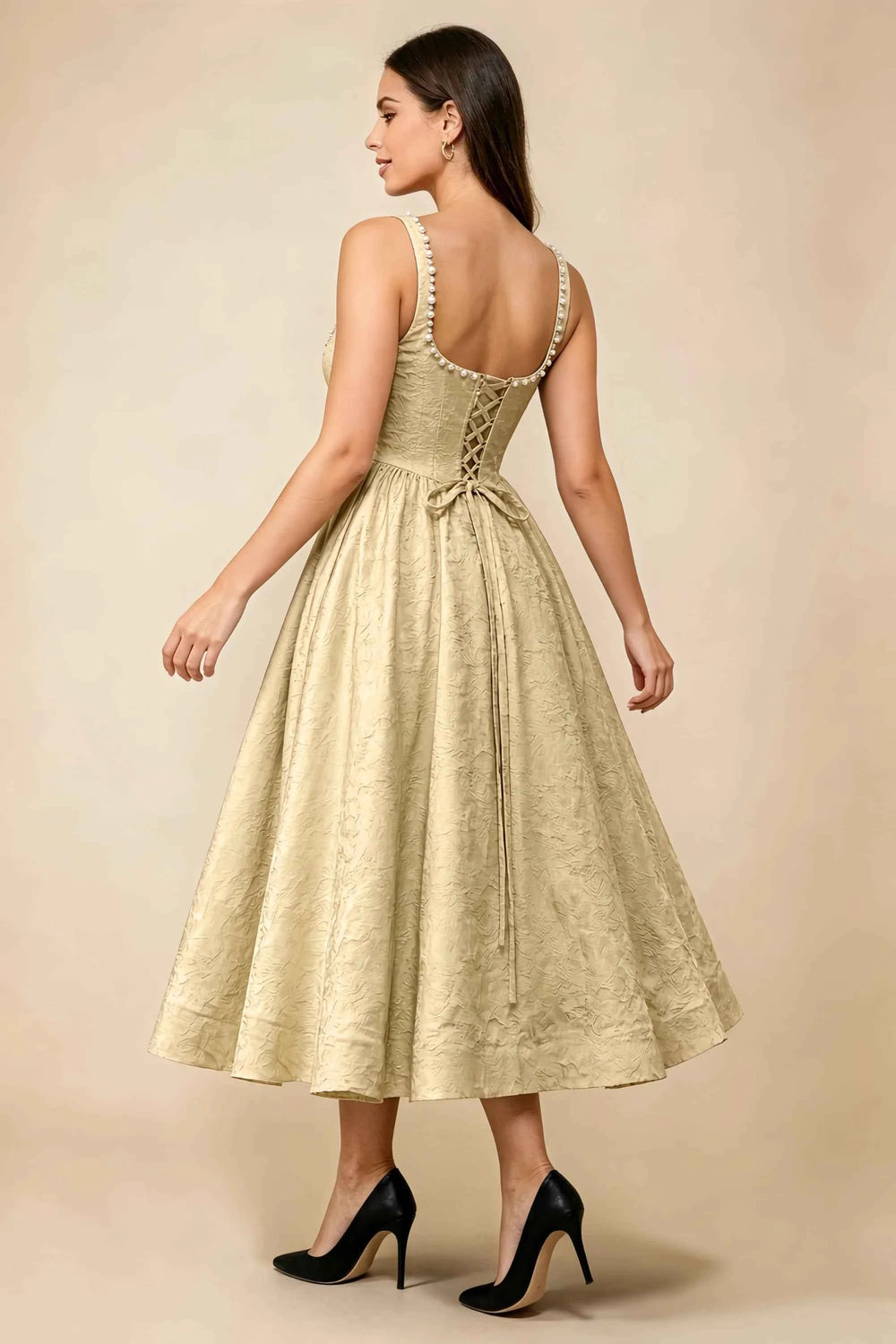 Translation missing: en.Rear three-quarter view of the LVLVS Alberta gold midi dress, showing the pearl-trimmed back neckline, lace-up bodice and full midi skirt. content.product_image_secondary