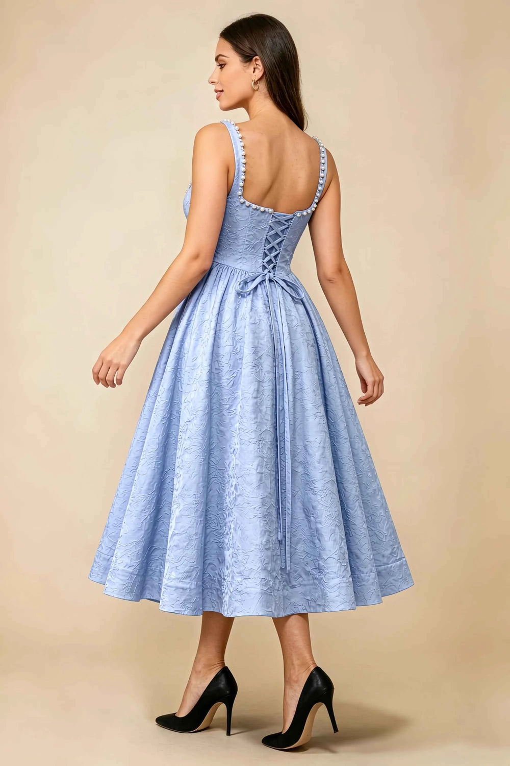 Translation missing: en.Rear three-quarter view of the LVLVS Alberta light blue midi dress, showing the pearl-trimmed back neckline, lace-up bodice and full midi skirt. content.product_image_secondary