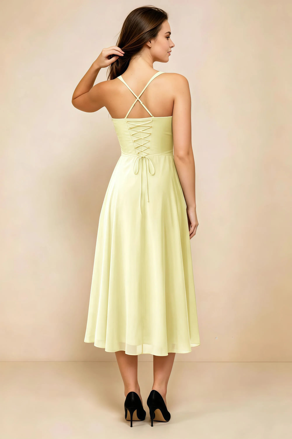 Translation missing: en.Back view of the LVLVS Alessandra butter yellow midi dress, showing the crossed straps, lace-up bodice and flowing midi skirt. content.product_image_secondary