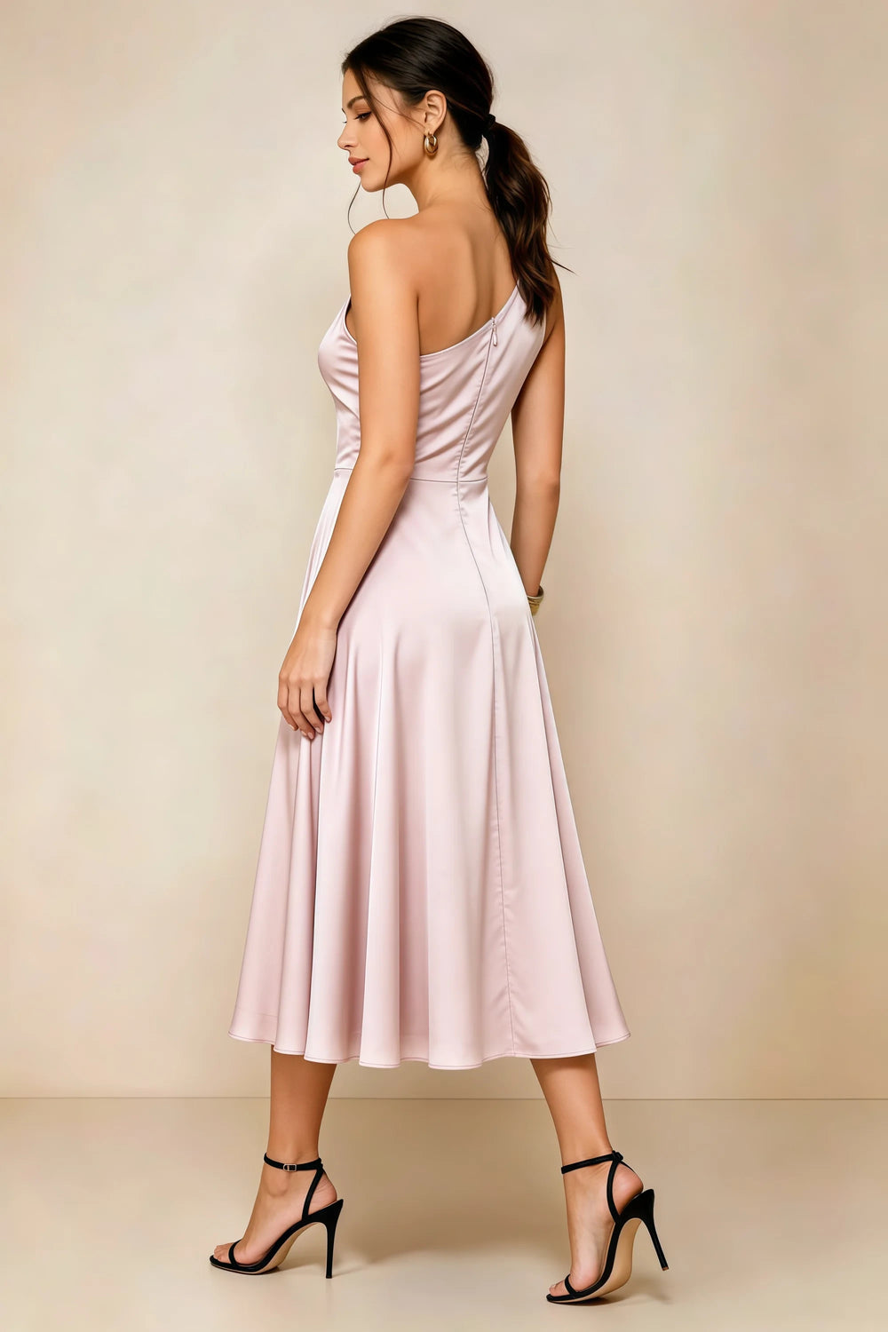 Translation missing: en.Rear three-quarter view of the LVLVS Alexa blush midi dress, showing the asymmetric back neckline, fitted waist and flared midi skirt. content.product_image_secondary