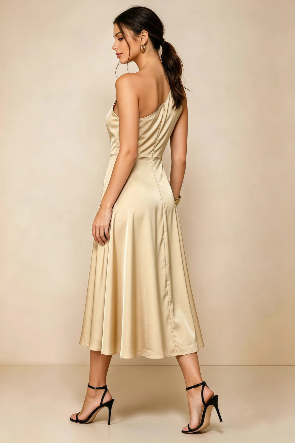 Translation missing: en.Rear three-quarter view of the LVLVS Alexa champagne midi dress, showing the asymmetric back neckline, fitted waist and flared midi skirt. content.product_image_secondary
