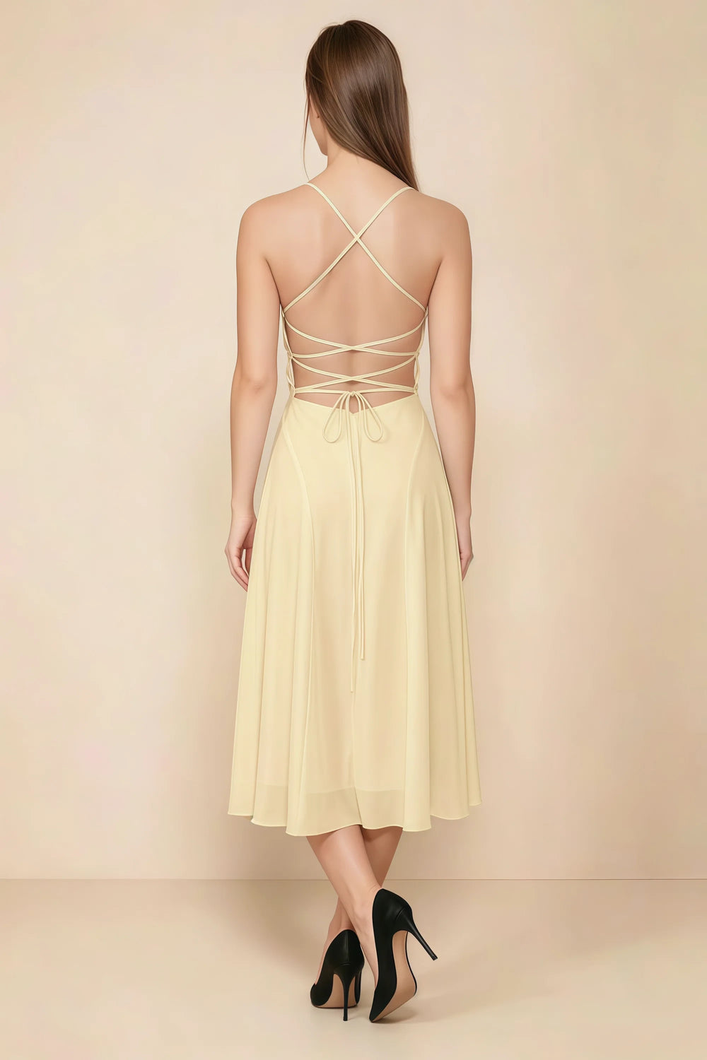 Translation missing: en.Back view of the LVLVS Alina lemon midi dress, showing the open back, crisscross straps and lace-up waist ties. content.product_image_secondary