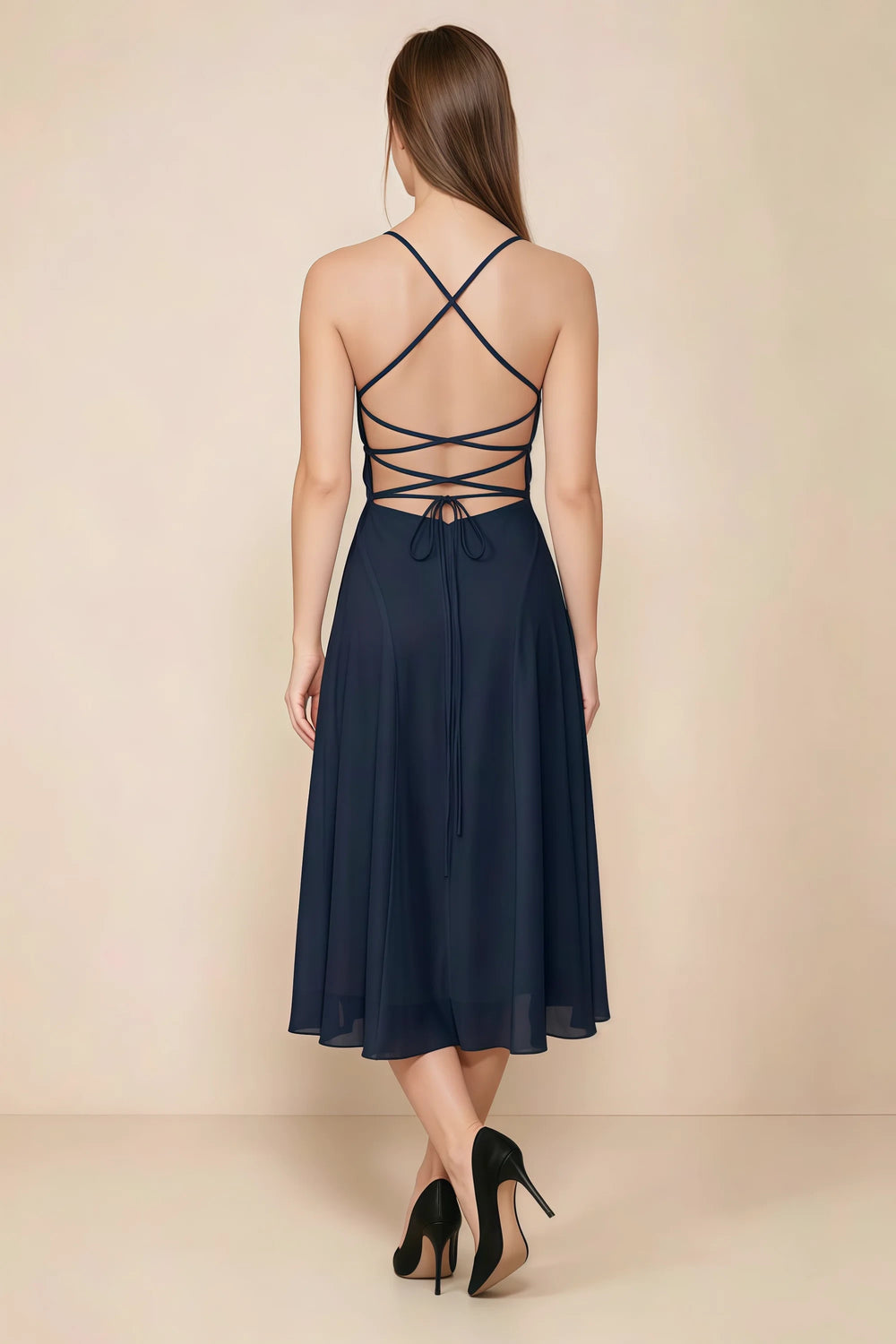 Translation missing: en.Back view of the LVLVS Alina navy midi dress, showing the open back, crisscross straps and lace-up waist ties. content.product_image_secondary