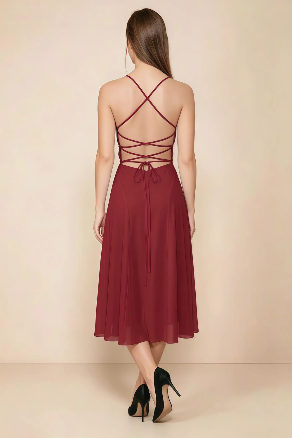 Translation missing: en.Back view of the LVLVS Alina rust midi dress, showing the open back, crisscross straps and lace-up waist ties. content.product_image_secondary