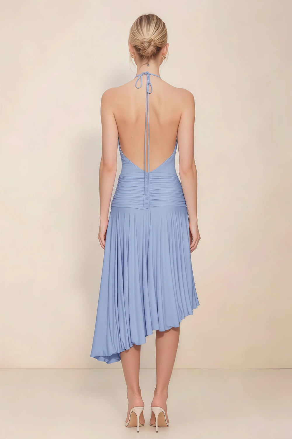 Translation missing: en.Back view of the LVLVS Amalia cornflower blue midi dress, showing the low open back, halter neck ties and uneven pleated hem. content.product_image_secondary