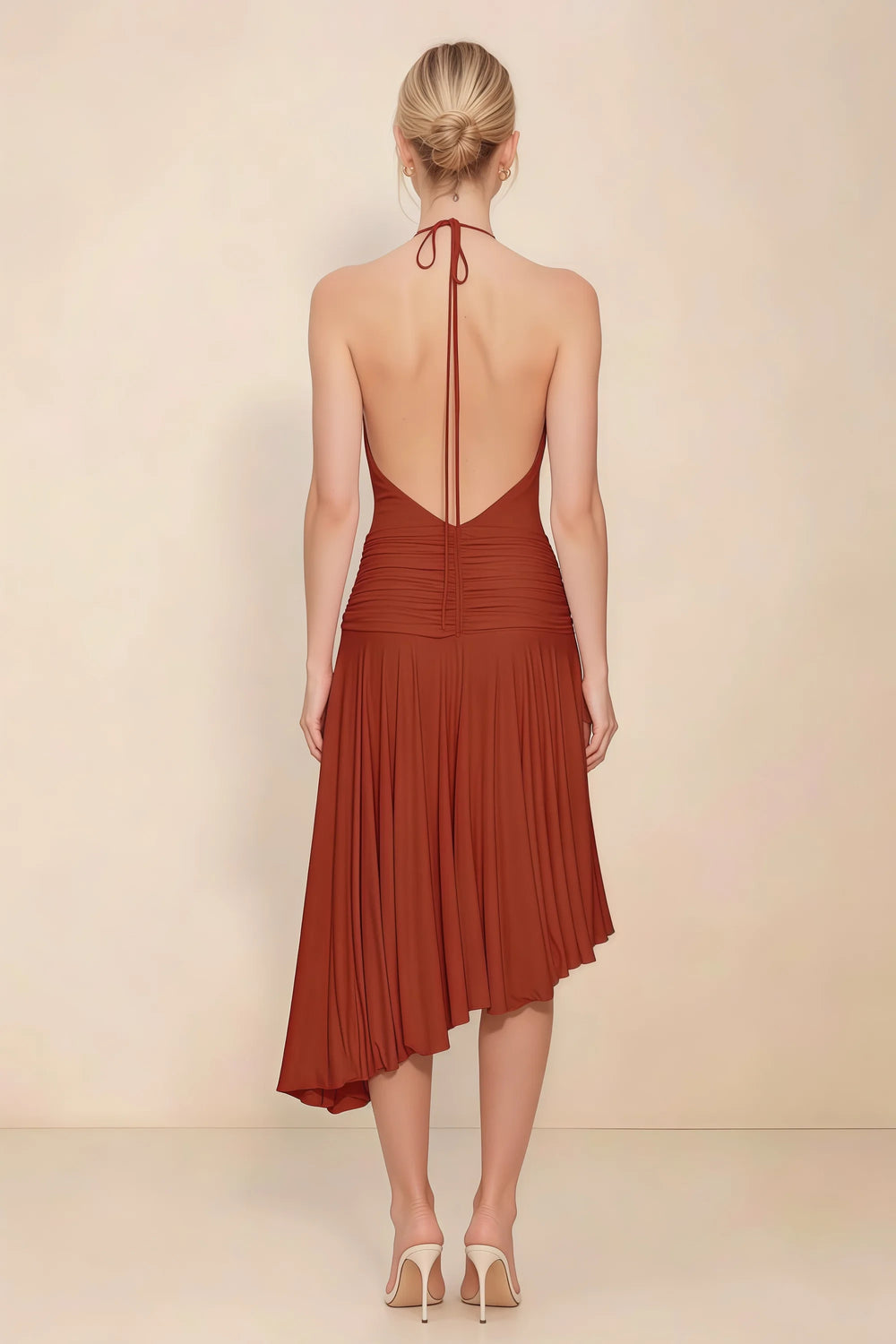 Translation missing: en.Back view of the LVLVS Amalia rust midi dress, showing the low open back, halter neck ties and uneven pleated hem. content.product_image_secondary