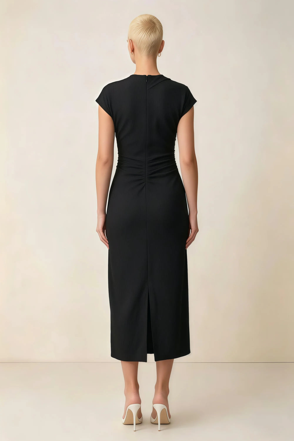 Translation missing: en.Back view of the LVLVS Anita black midi dress, showing the covered back, gathered waist and center skirt slit. content.product_image_secondary