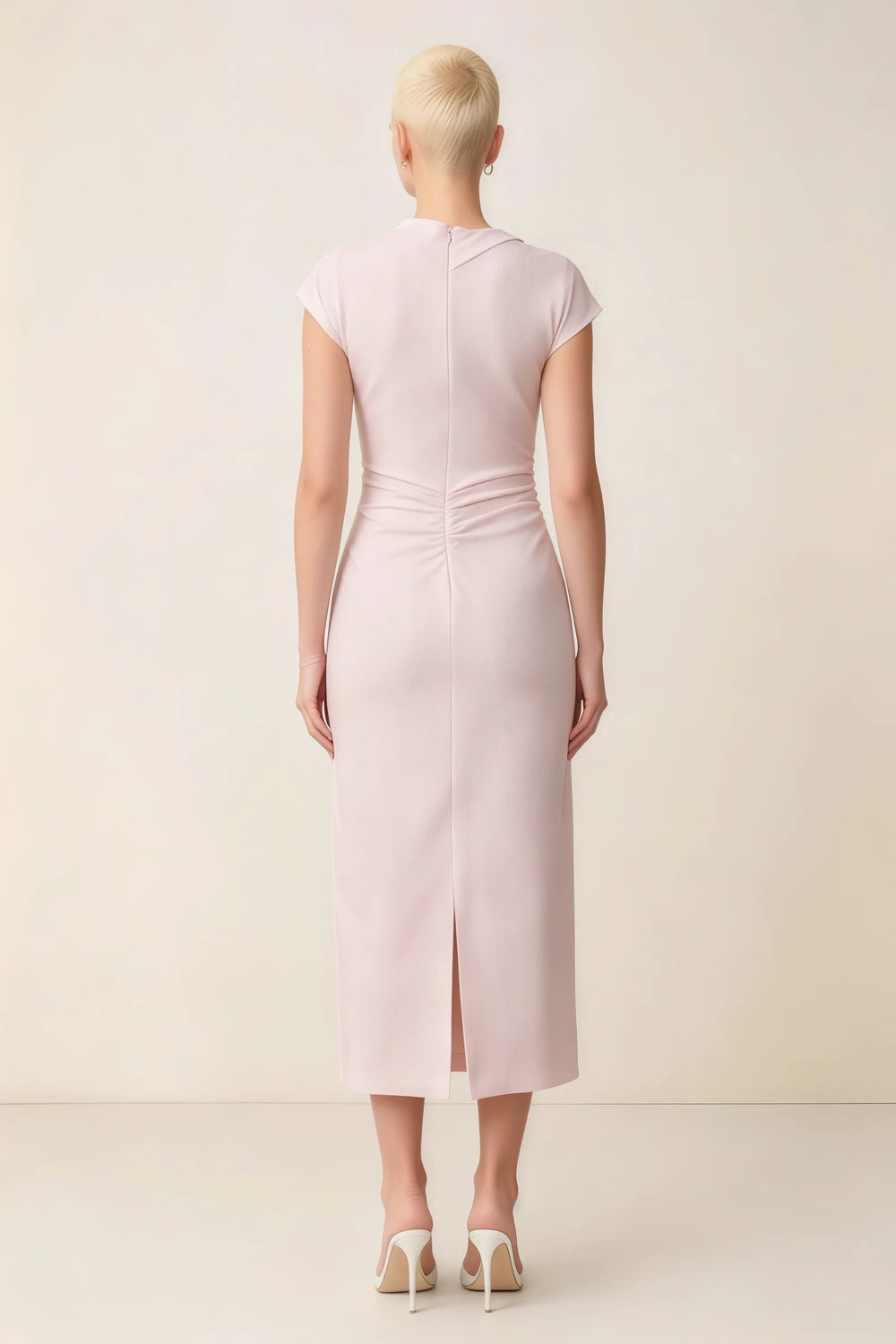 Translation missing: en.Back view of the LVLVS Anita blush midi dress, showing the covered back, gathered waist and center skirt slit. content.product_image_secondary