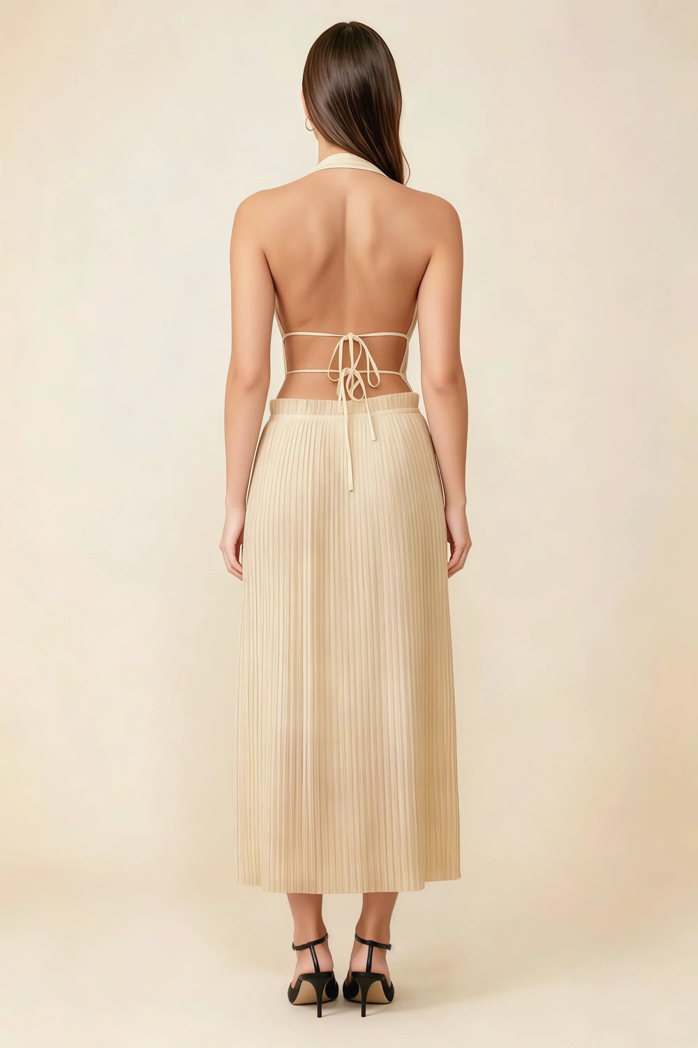 Translation missing: en.Back view of the LVLVS Arabella champagne midi dress showing the open back, lace-up waist ties and pleated skirt. content.product_image_secondary