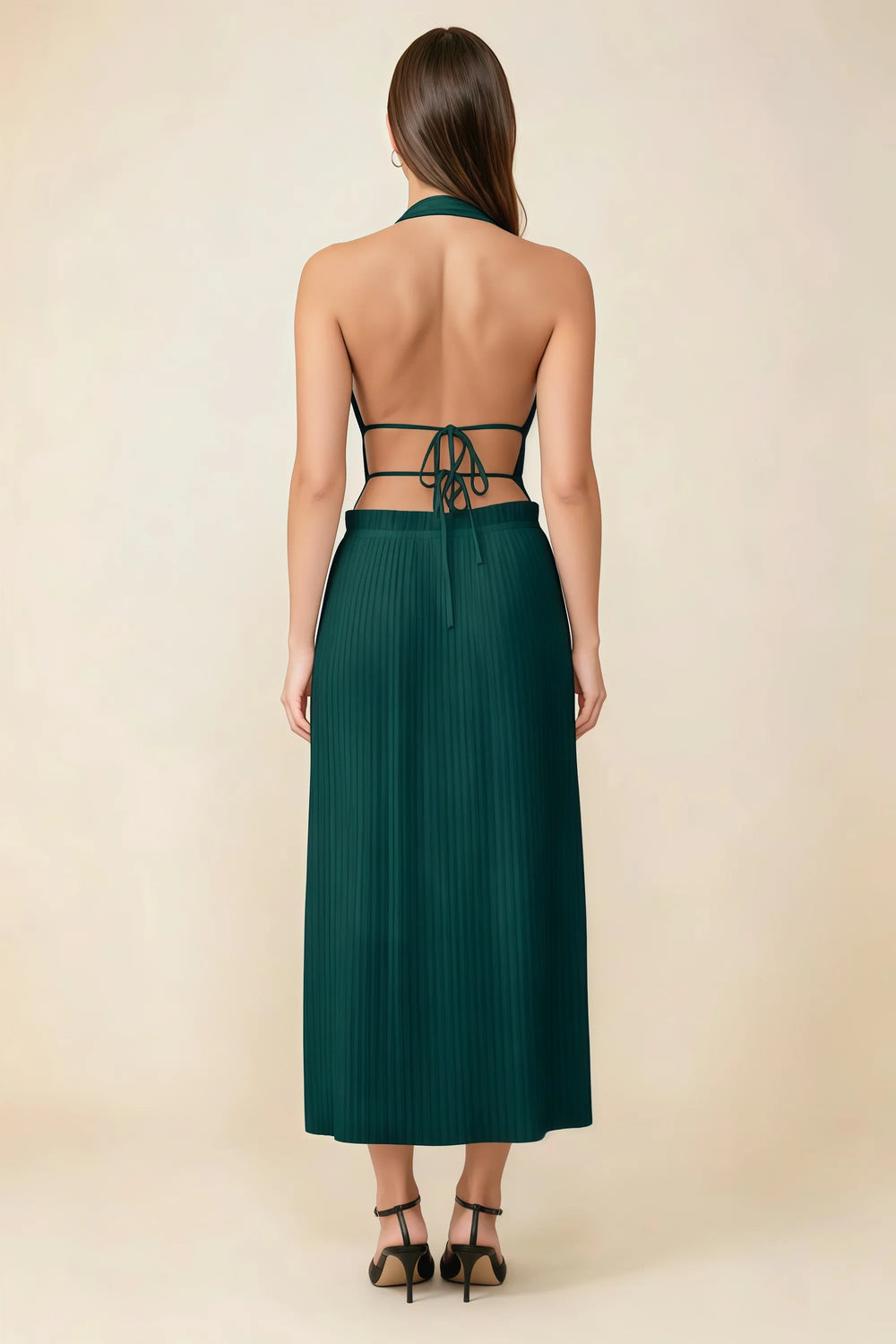 Translation missing: en.Back view of the LVLVS Arabella emerald green midi dress showing the open back, lace-up waist ties and pleated skirt. content.product_image_secondary