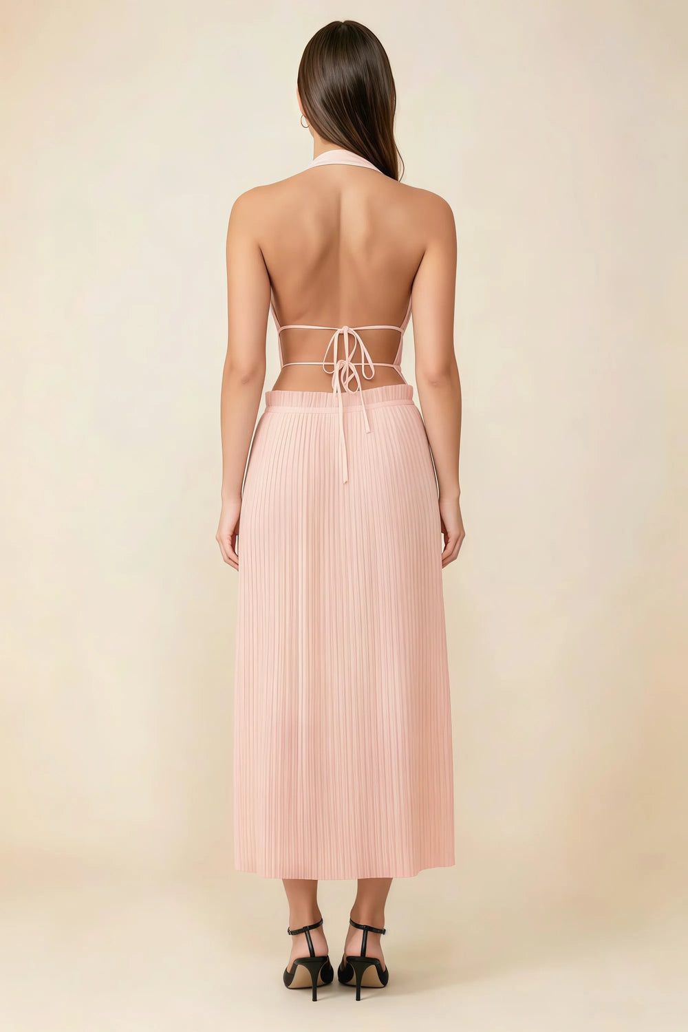 Translation missing: en.Back view of the LVLVS Arabella light pink midi dress showing the open back, lace-up waist ties and pleated skirt. content.product_image_secondary
