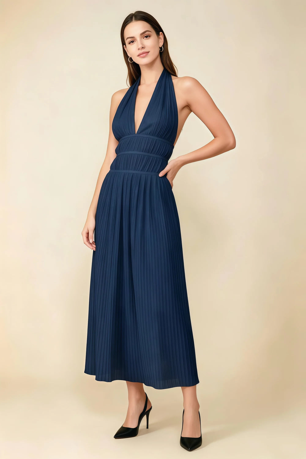 Translation missing: en.Front view of the LVLVS Arabella navy pleated midi dress with a deep V halter neckline and defined waist. content.product_image_main