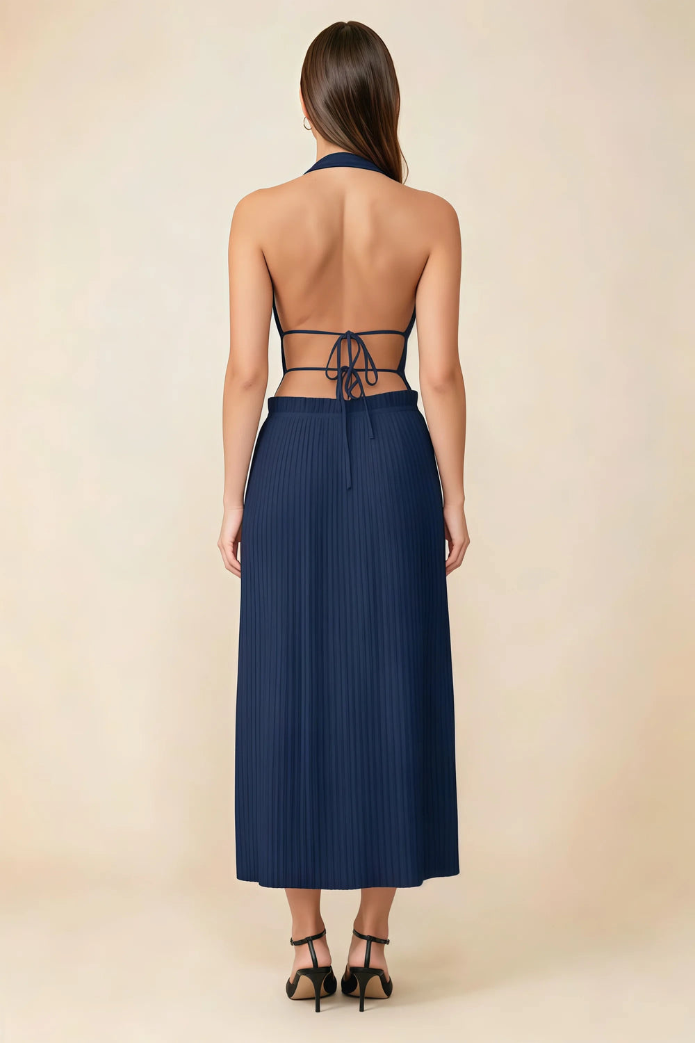 Translation missing: en.Back view of the LVLVS Arabella navy midi dress showing the open back, lace-up waist ties and pleated skirt. content.product_image_secondary
