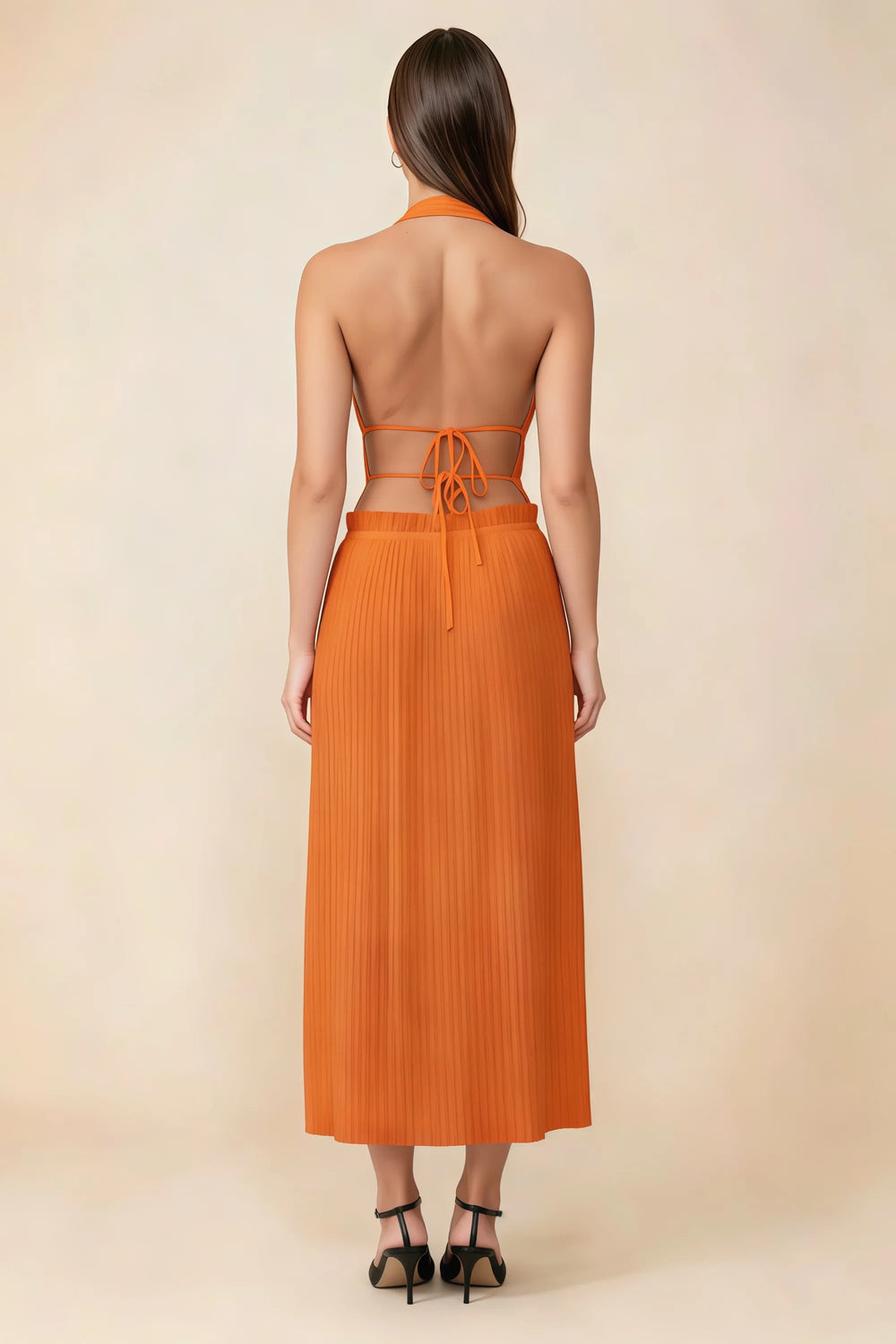 Translation missing: en.Back view of the LVLVS Arabella orange midi dress showing the open back, lace-up waist ties and pleated skirt. content.product_image_secondary