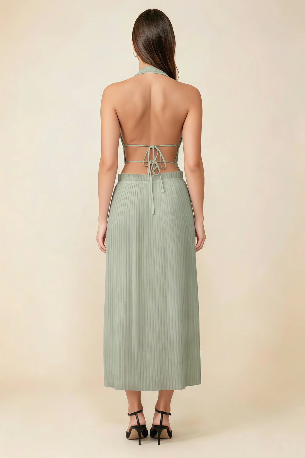 Translation missing: en.Back view of the LVLVS Arabella sage green midi dress showing the open back, lace-up waist ties and pleated skirt. content.product_image_secondary