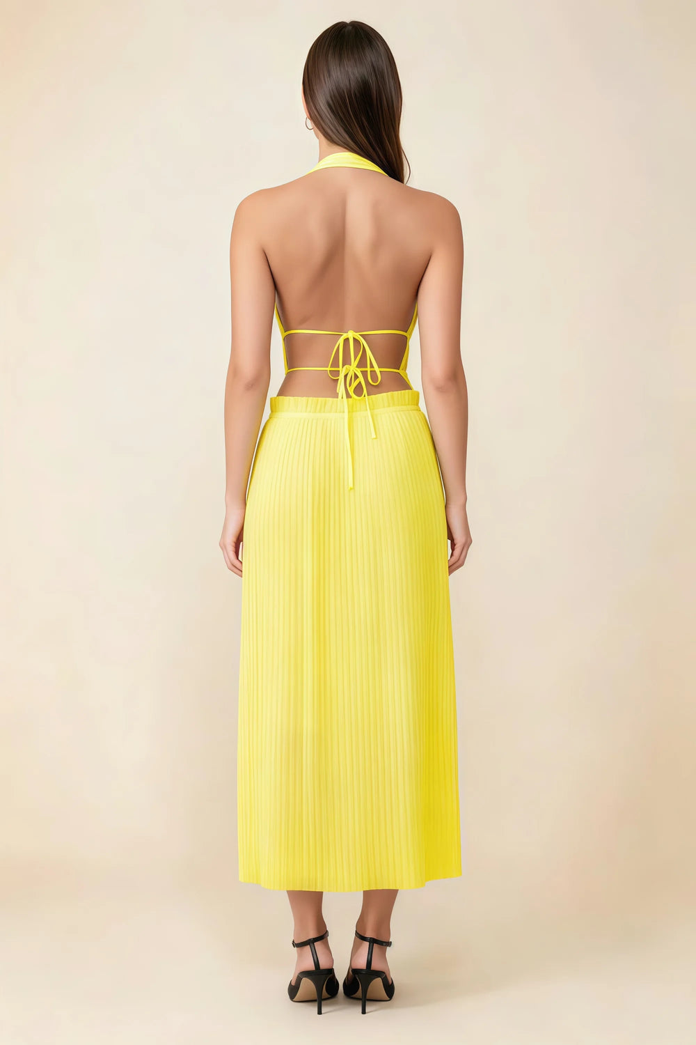 Translation missing: en.Back view of the LVLVS Arabella yellow midi dress showing the open back, lace-up waist ties and pleated skirt. content.product_image_secondary