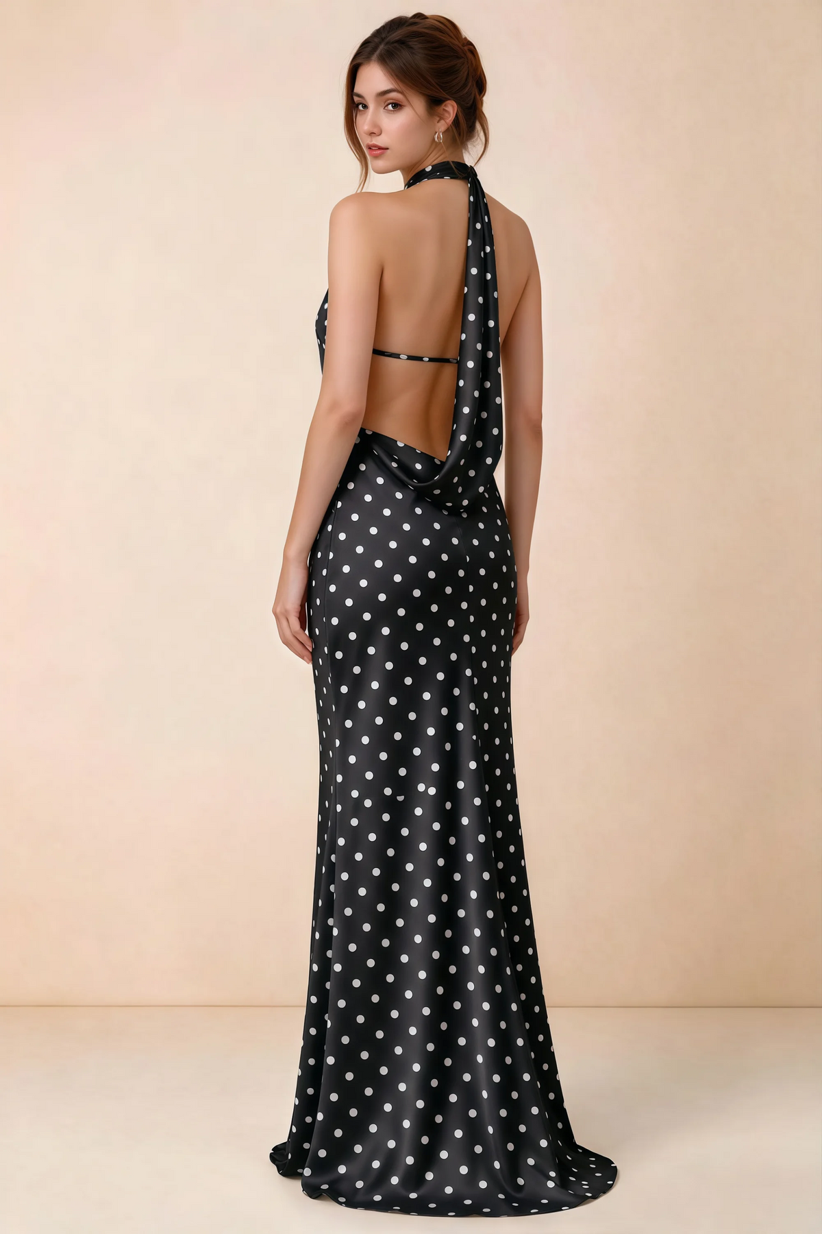 Back view of Astrid black polka dot halter maxi dress, highlighting the open draped back.