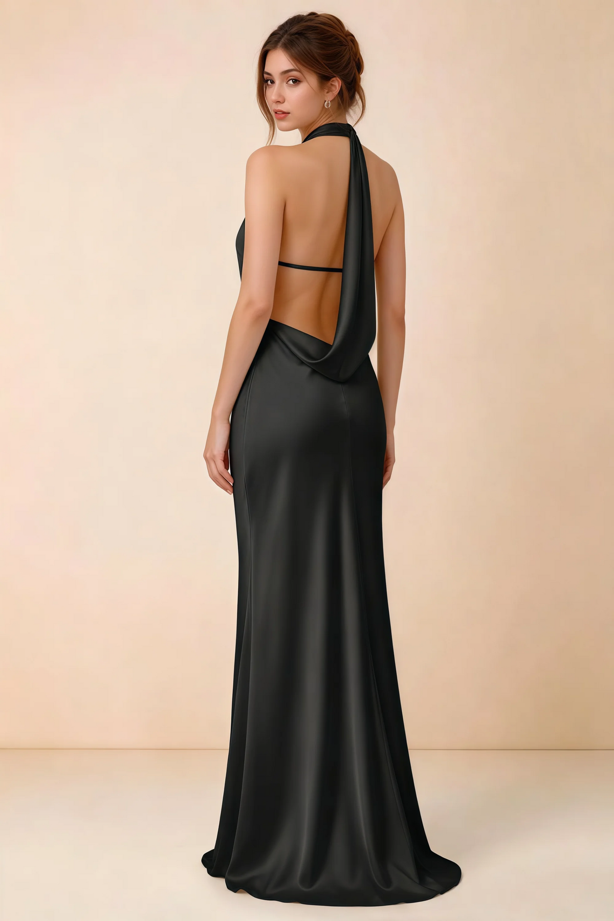 Back view of the Astrid black satin maxi dress, showing the low open back, slim horizontal strap and draped cowl panel.