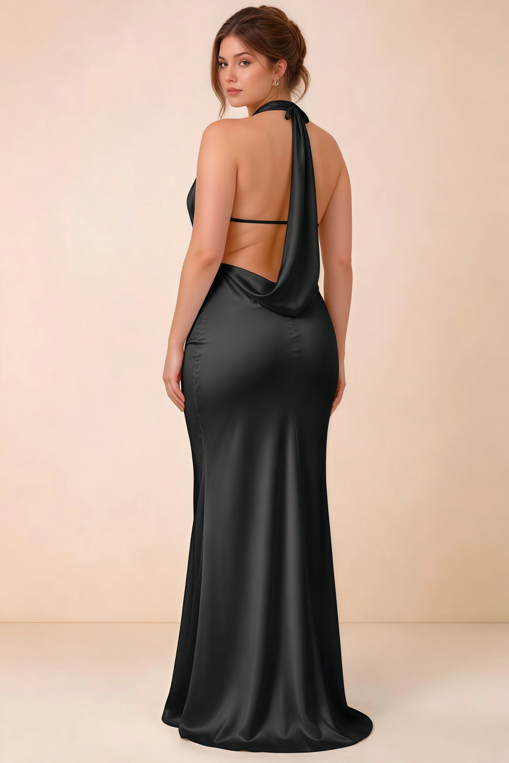 Rear three-quarter view of the Astrid black satin maxi dress, showing the halter ties, slim back strap and cowl detail.